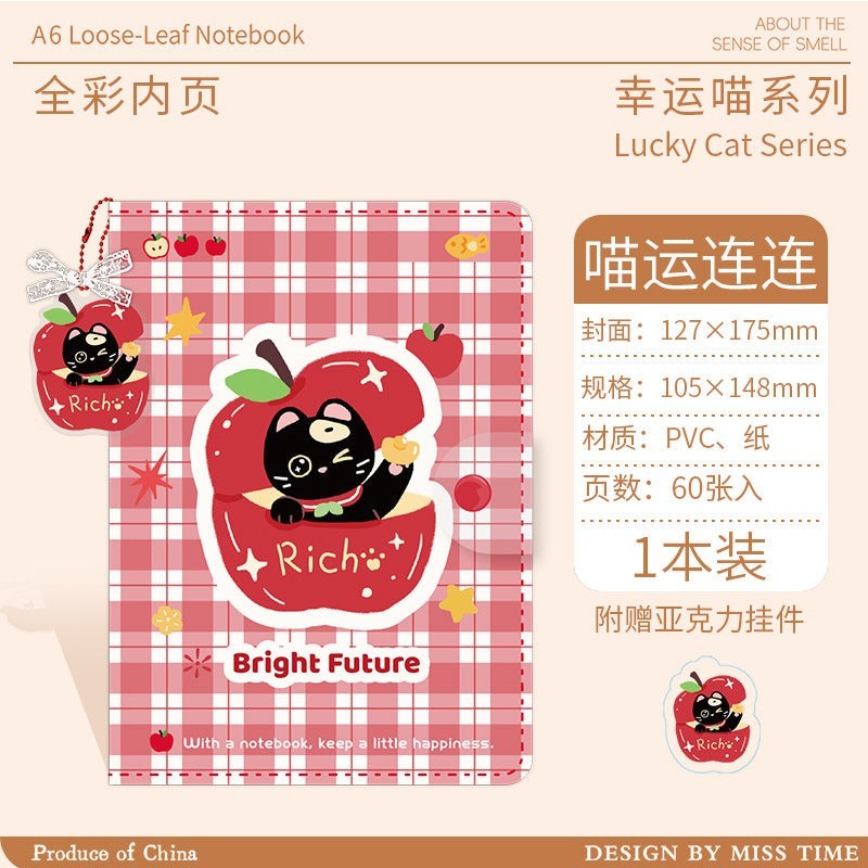 StationeryHaul A6 planner with red plaid cover, cute black cat in apple illustration, and matching acrylic charm