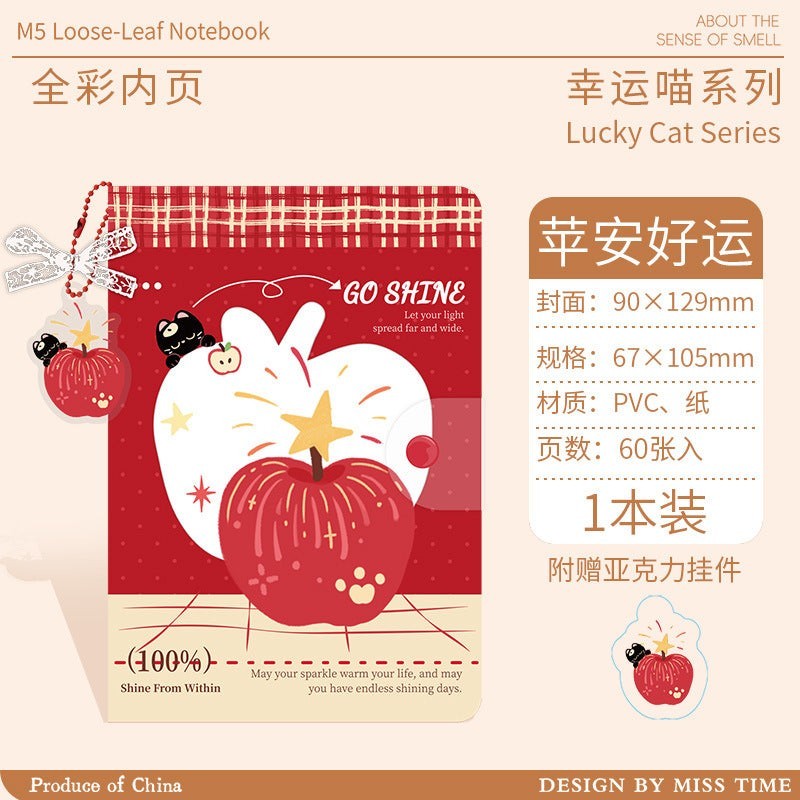 StationeryHaul A6 planner refill featuring a red apple illustration, lucky cat character, and acrylic charm.