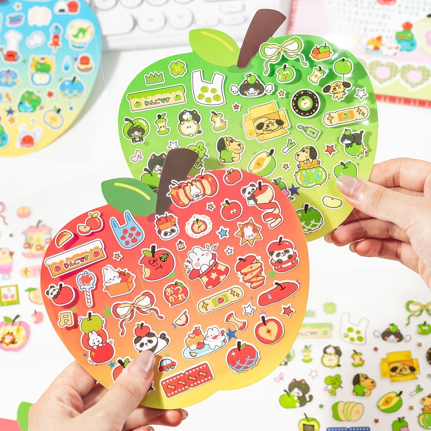 StationeryHaul cute apple shaped sticker sheets with pandas, bunnies, dogs, and apples in red, yellow, and green gradients.