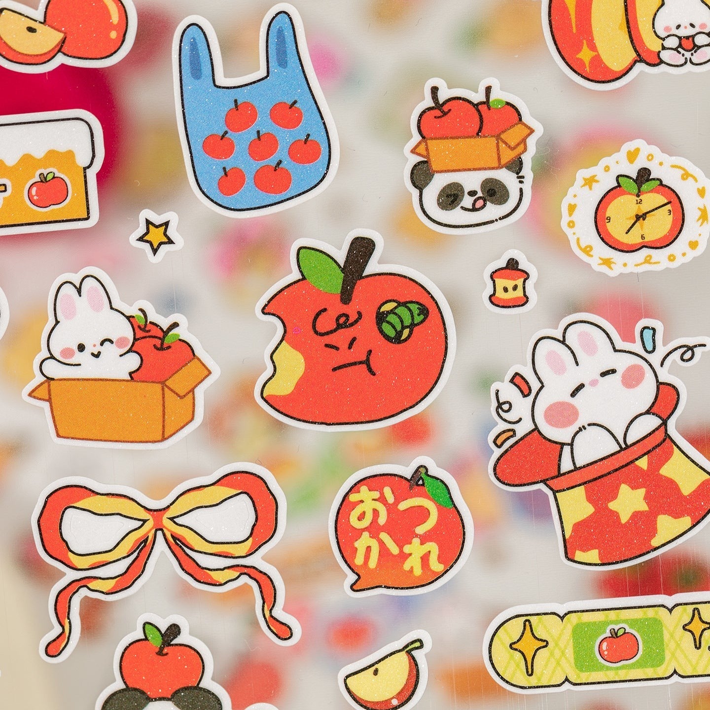StationeryHaul cute apple-shaped sticker sheets with kawaii pandas, bunnies, dogs, and bows in vibrant red, yellow, and green.