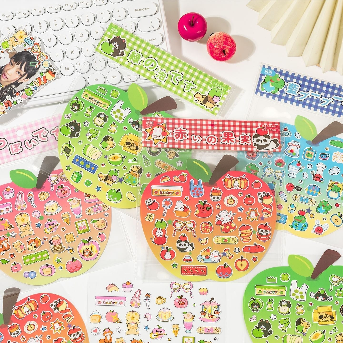 StationeryHaul cute apple shaped sticker sheets featuring pandas, bunnies, dogs, and apples in red, yellow, and green gradients.