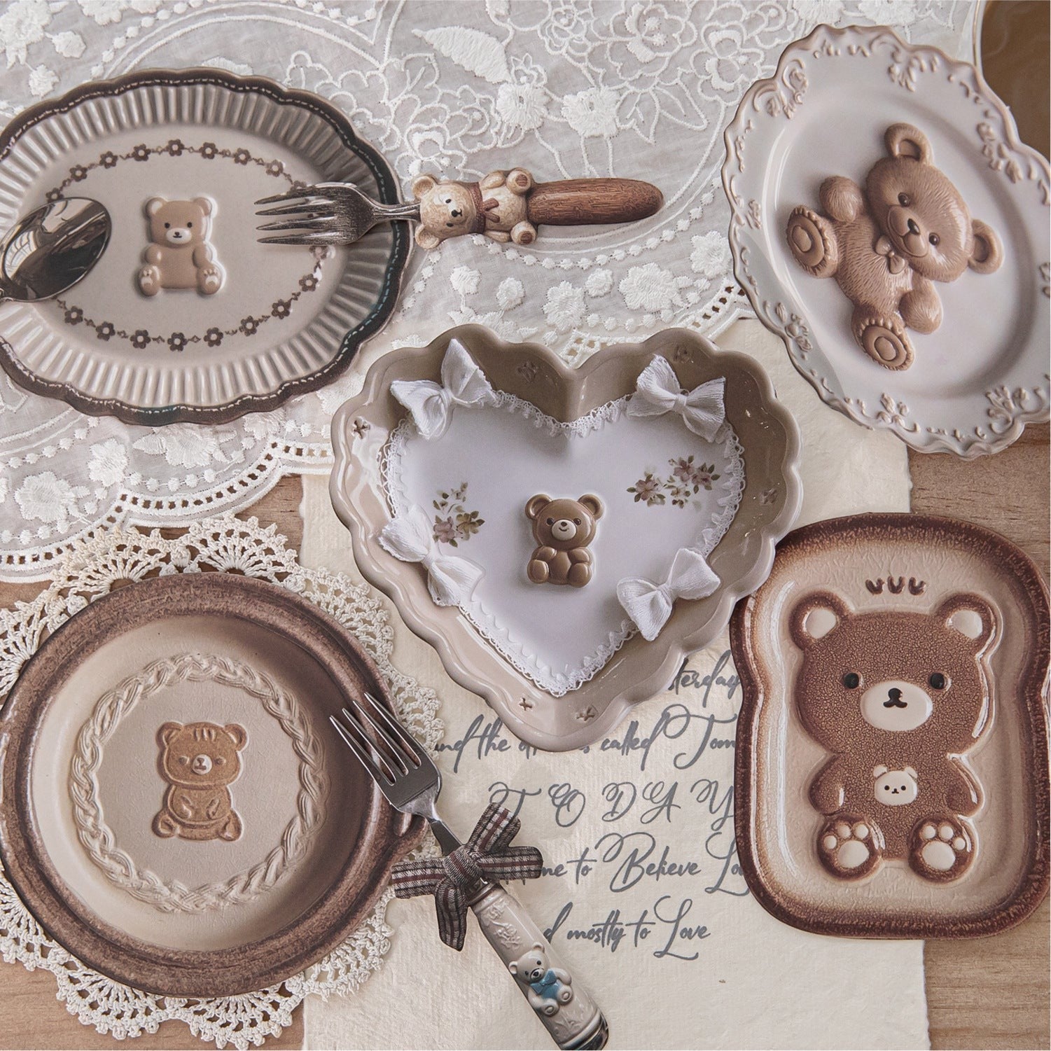 StationeryHaul decorative plates and cutlery set with teddy bear designs. Includes heart and toast-shaped plates and cutlery with bear motifs.
