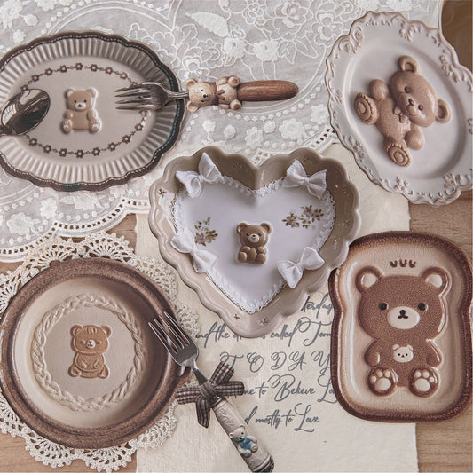 StationeryHaul decorative plates and cutlery set with teddy bear designs. Includes heart and toast-shaped plates and cutlery with bear motifs.
