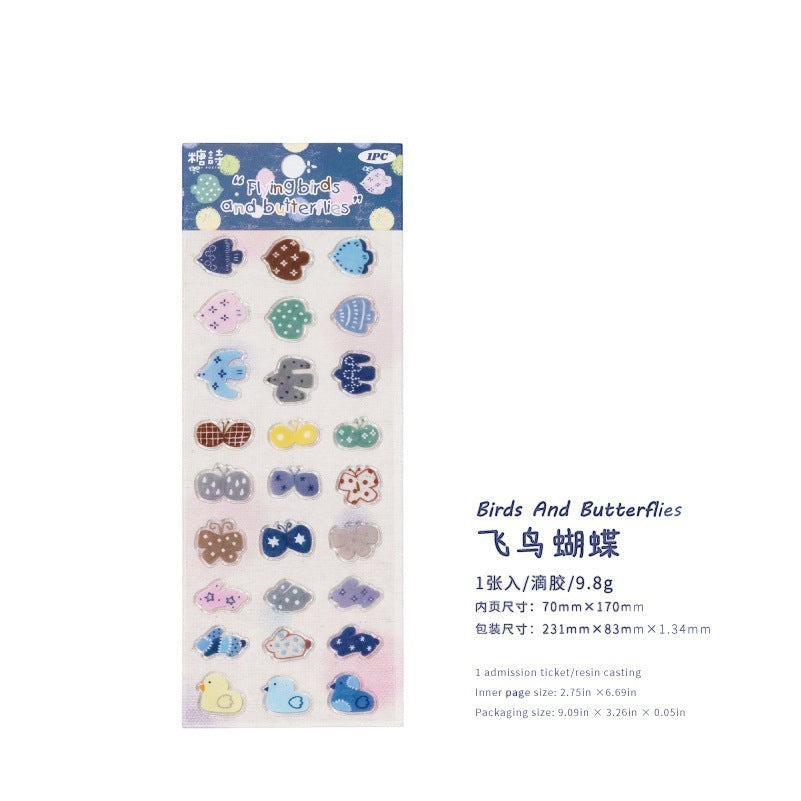 StationeryHaul adhesive sticker sheet featuring colorful birds, butterflies, and whimsical motifs on transparent backing
