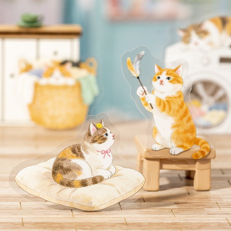 StationeryHaul transparent cat stickers: calico cat on cushion, orange tabby playing with feather wand.