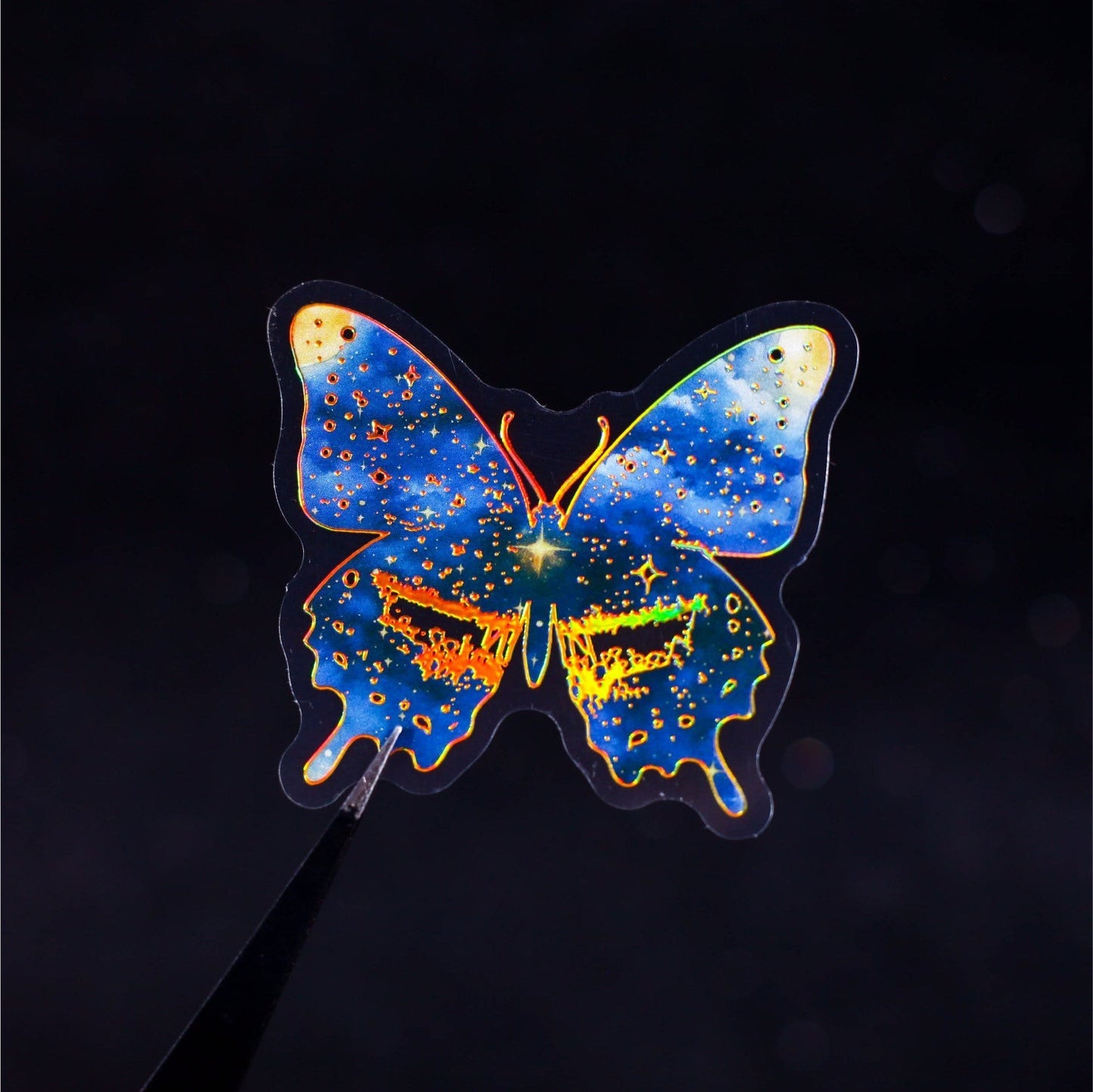 StationeryHaul holographic butterfly sticker with celestial galaxy design in blue, purple, and gold.