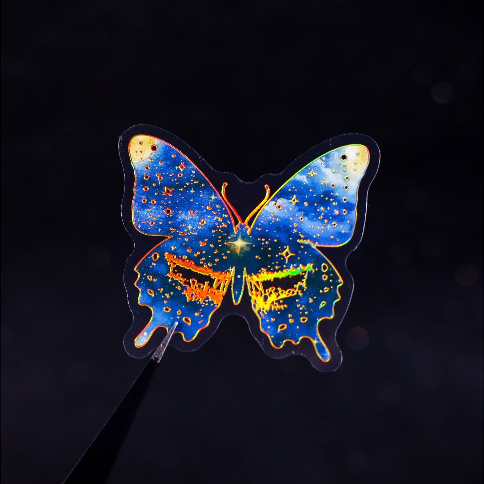 StationeryHaul holographic butterfly sticker with celestial galaxy design in blue, purple, and gold.