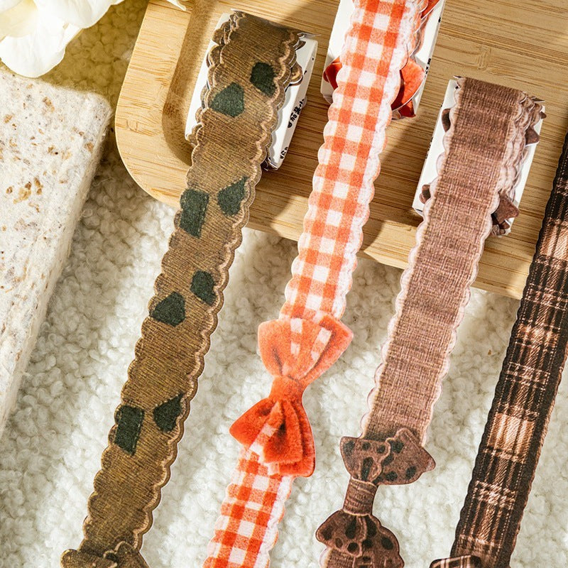 StationeryHaul decorative craft ribbon with bow accents in plaid and patterned designs. Features scalloped edges.