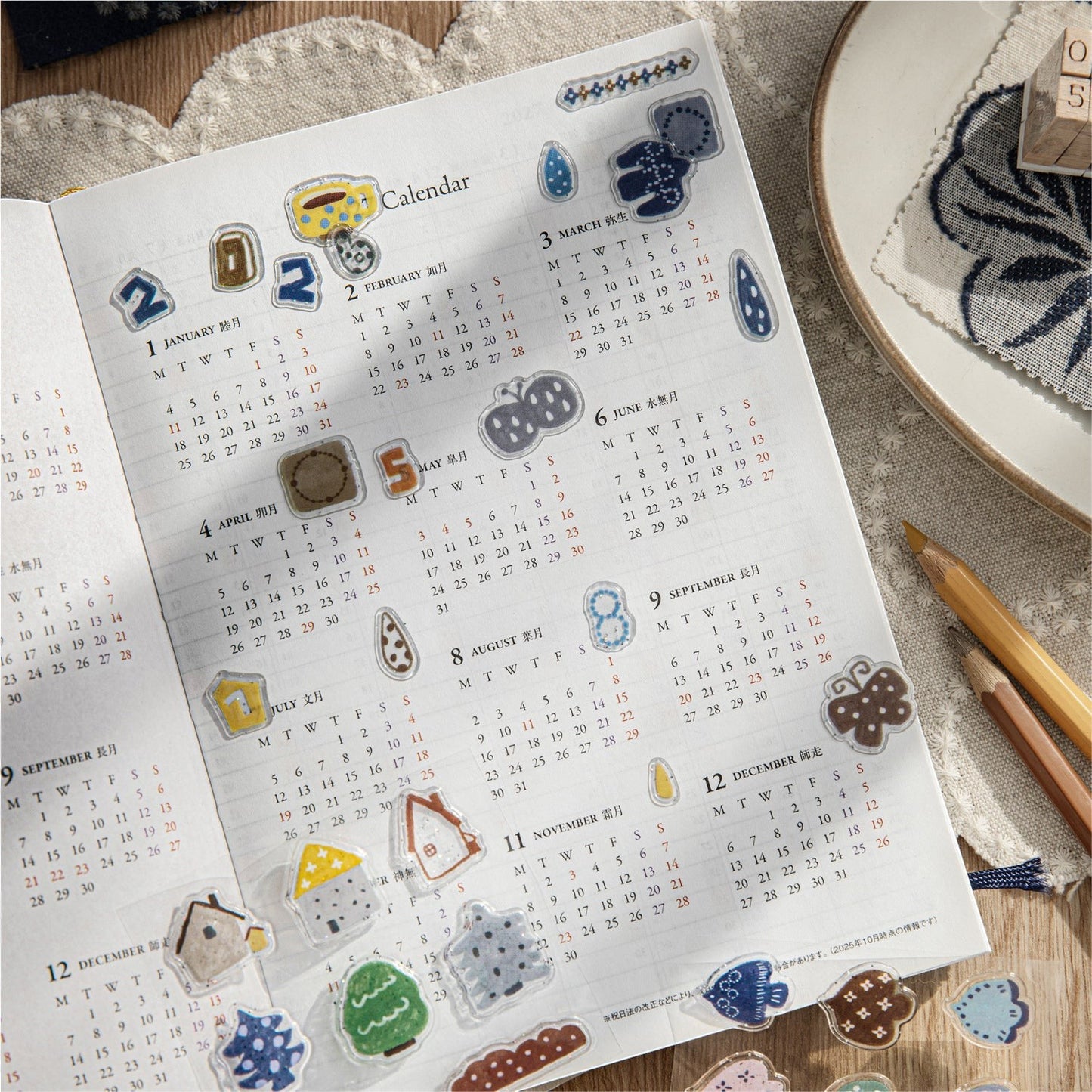 StationeryHaul decorative adhesive sticker sheets with whimsical coffee, nature, and star motifs on a planner page.