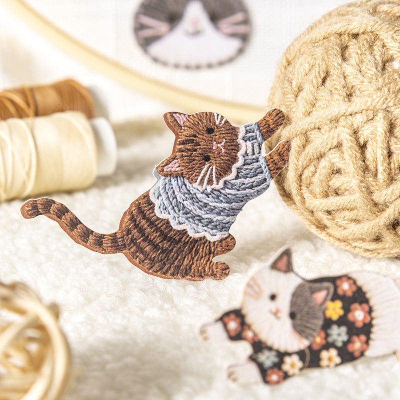 StationeryHaul embroidered cat sticker featuring a brown tabby cat in a blue sweater playing with a ball of yarn