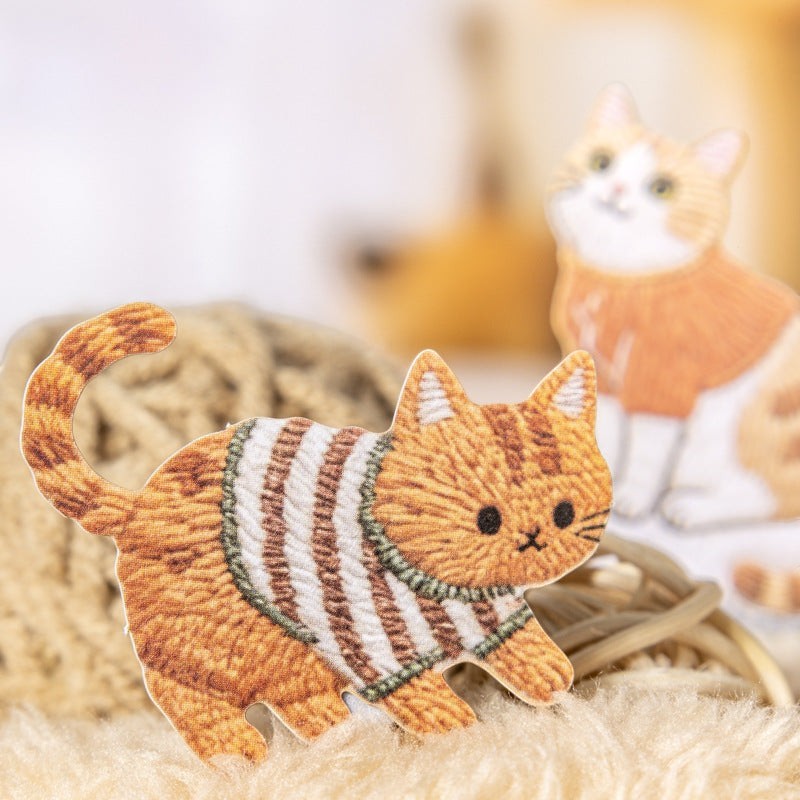 StationeryHaul embroidered cat sticker featuring a ginger tabby wearing a striped sweater for journaling