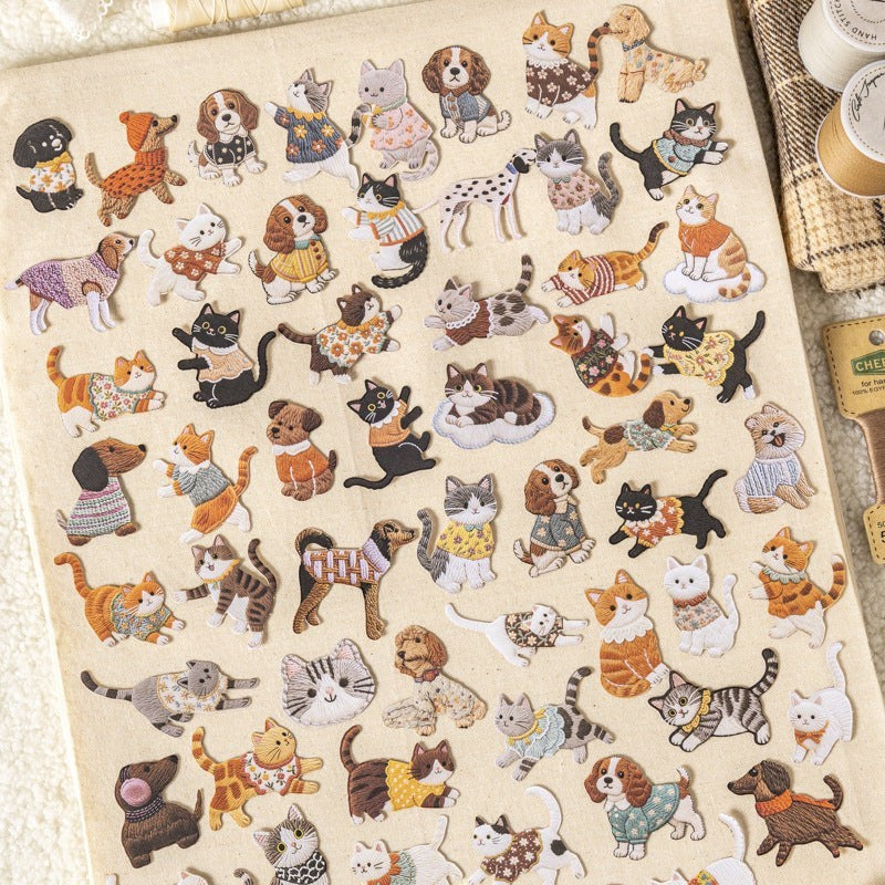 StationeryHaul embroidered style pet stickers featuring various cats and dogs in colorful outfits on fabric background