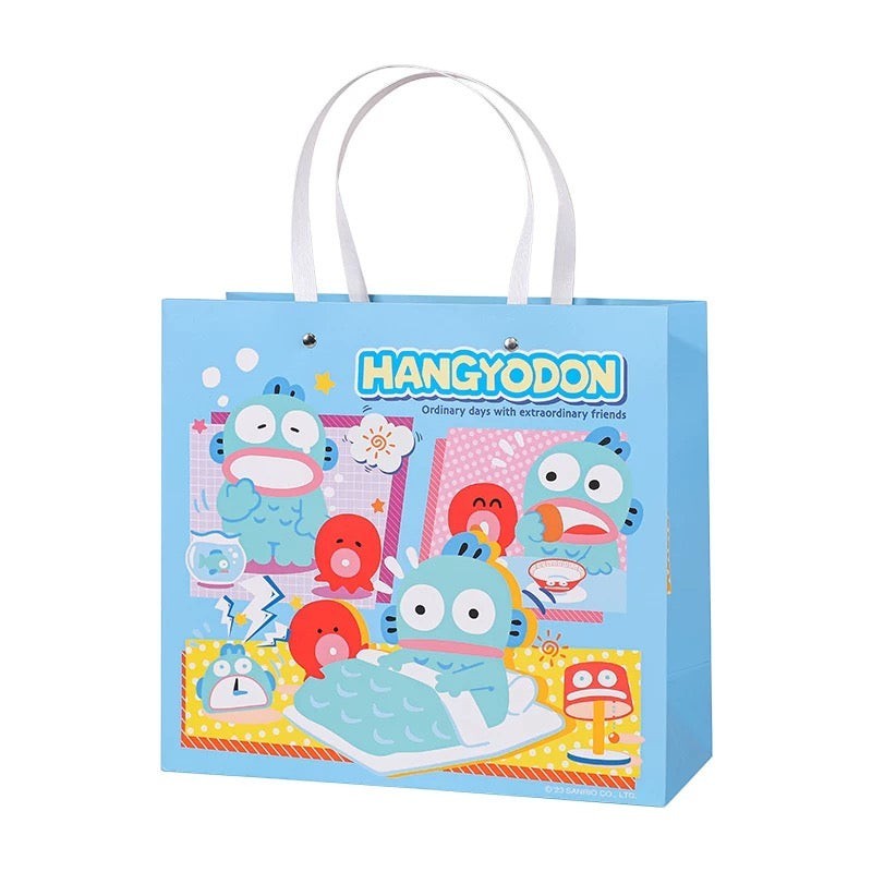 StationeryHaul light blue paper gift bag with Hangyodon character graphics and white handles.