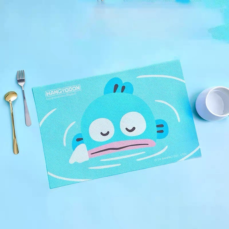 StationeryHaul blue Hangyodon placemat with a textured surface and a cute cartoon character design. Includes cutlery and a cup.