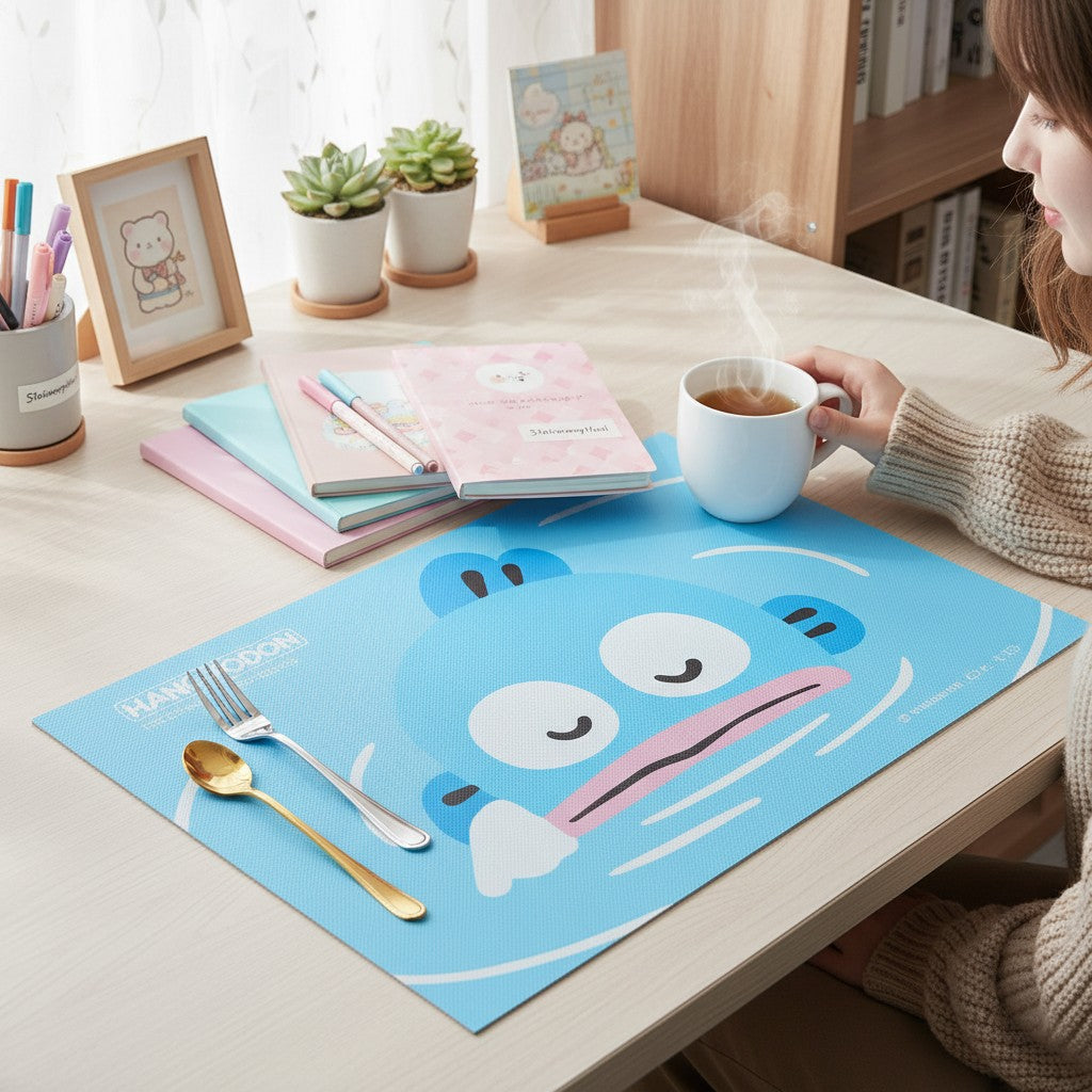 StationeryHaul blue Hangyodon character placemat with cutlery and a cup of tea on a table.