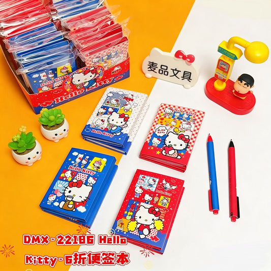 StationeryHaul Hello Kitty accordion memo pads in red and blue with colorful character illustrations on a desk