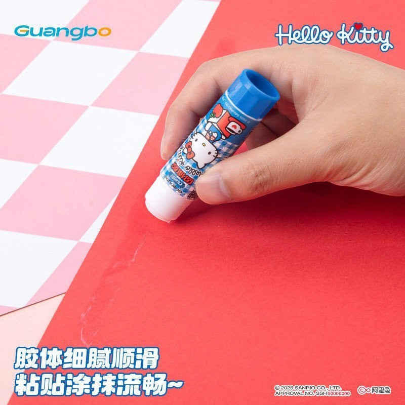 StationeryHaul Hello Kitty glue stick being used on red paper with blue cap and Sanrio character design