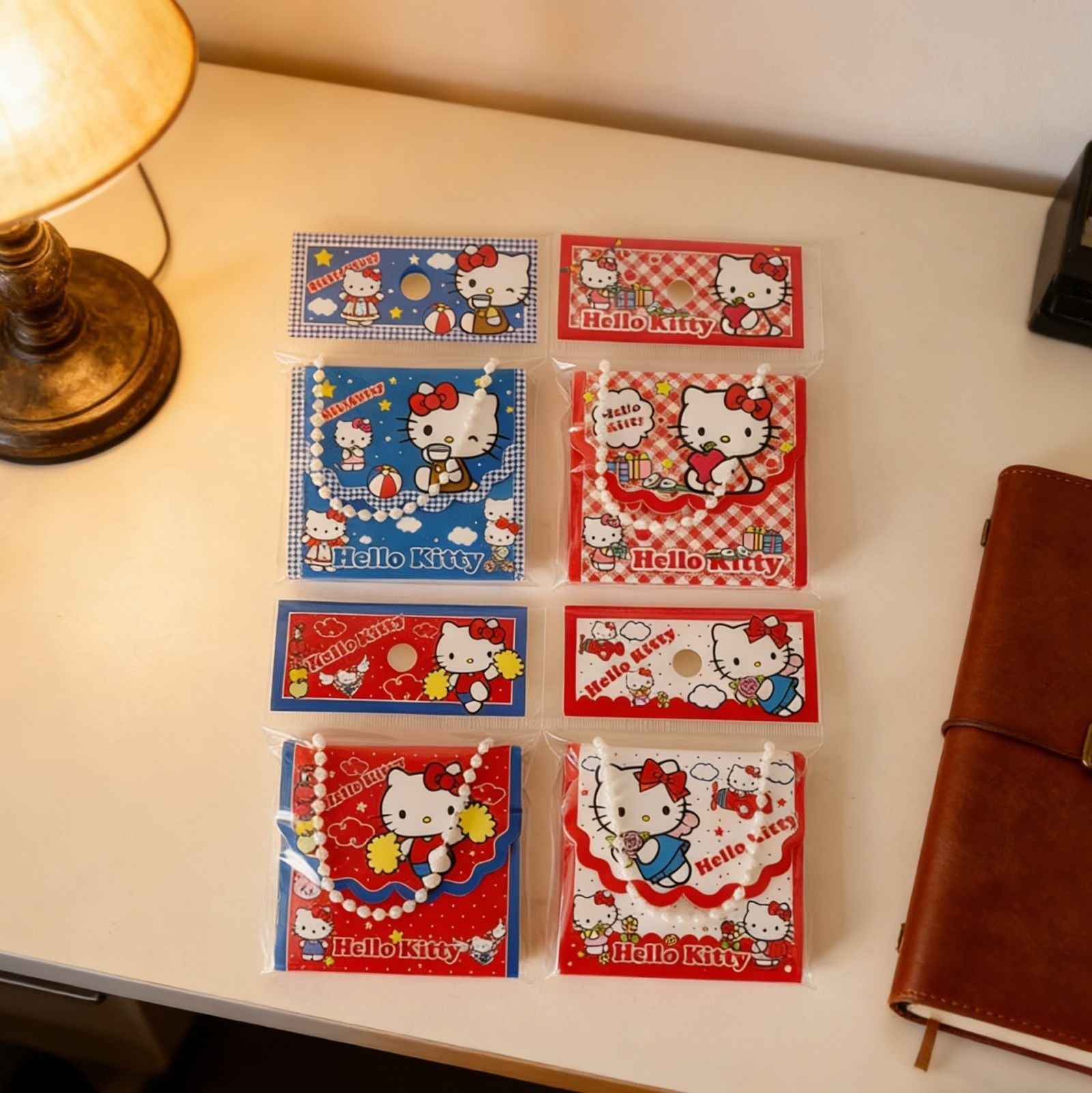 StationeryHaul Hello Kitty tote bag shaped folding notebooks with pearl chain handles in red and blue packaging