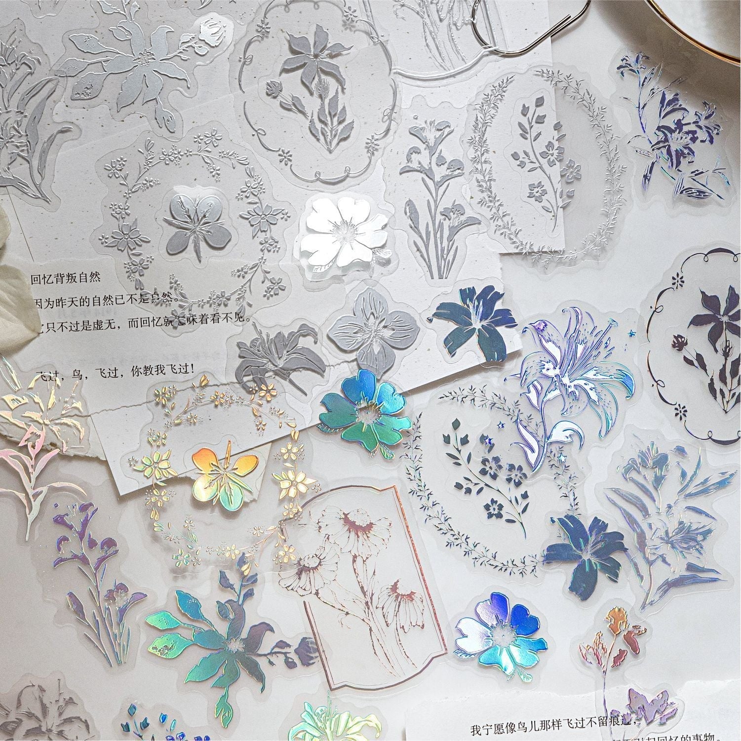 StationeryHaul iridescent butterfly and floral decorative stickers with transparent finish. Includes delicate butterflies, flowers, and foliage.