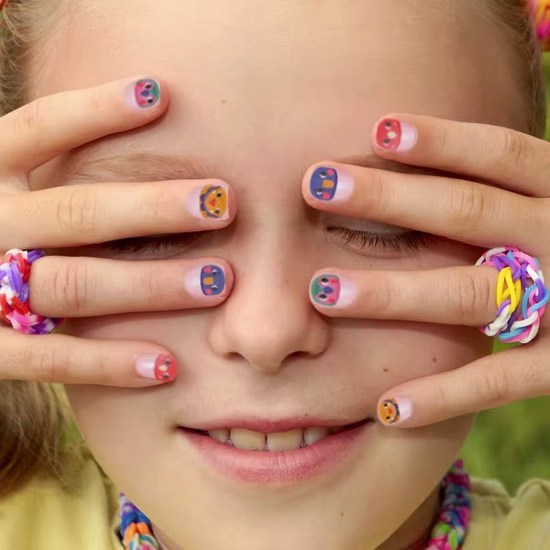 StationeryHaul Mideer nail stickers featuring colorful cartoon faces on a child's fingernails.