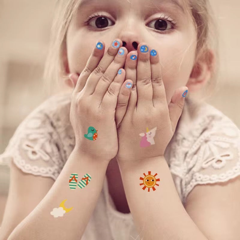 StationeryHaul Mideer nail stickers featuring a unicorn, dinosaur, sun, moon, clouds, and flip-flops on a child's hands and arms.