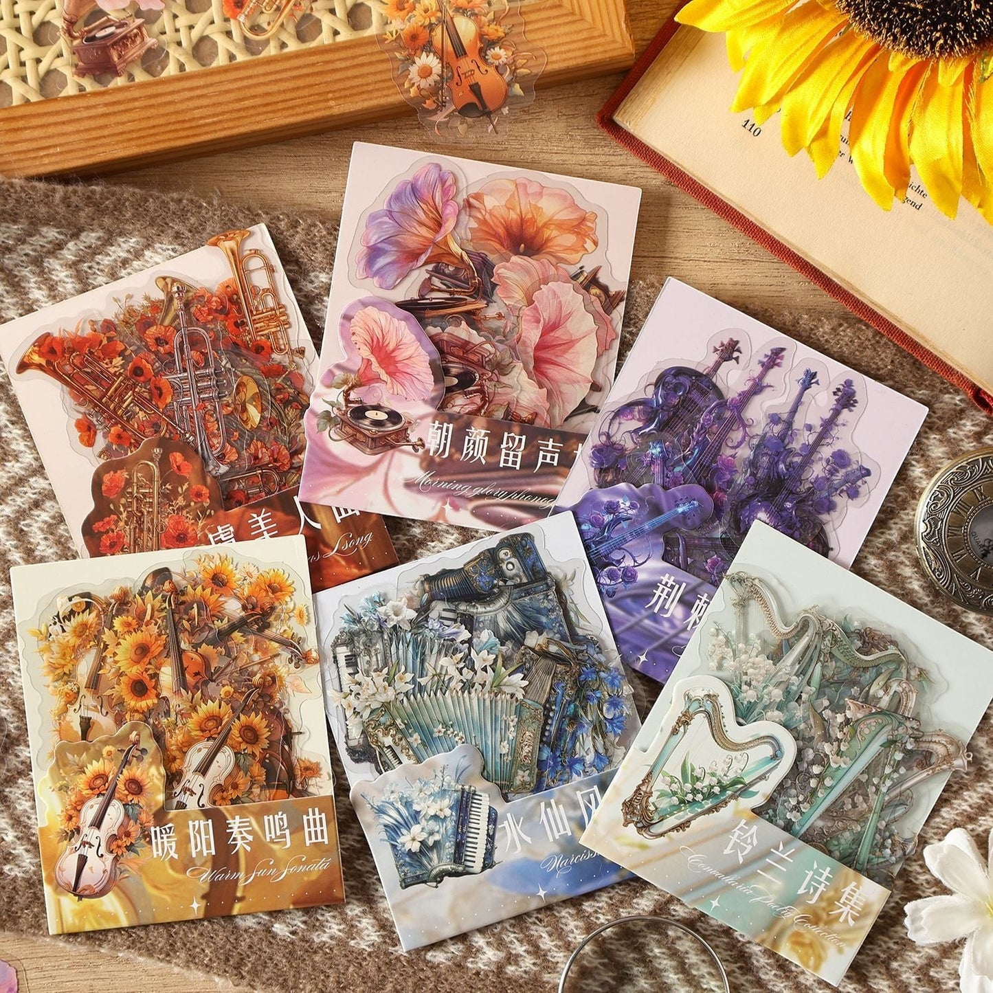 StationeryHaul Musical Instruments and Floral Decorative Sticker Set featuring violins, harps, accordions, and brass instruments with vibrant floral motifs. Transparent material.