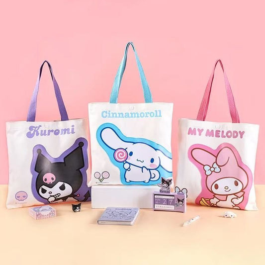 StationeryHaul white canvas tote bags featuring Kuromi, Cinnamoroll, and My Melody characters. Each bag has a large graphic and colored handles.