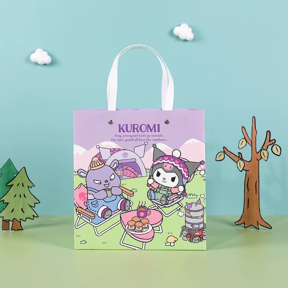 StationeryHaul purple paper gift bag with Kuromi and a purple bear character camping scene. Features handles and a cute outdoor graphic.