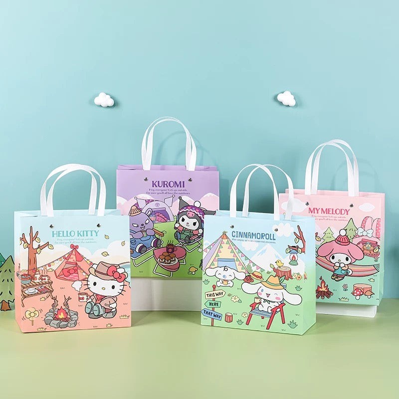 StationeryHaul Sanrio Characters gift bags set featuring Hello Kitty, My Melody, Kuromi, Cinnamoroll, Pochacco, and Hangyodon camping designs. Paper bags with handles.