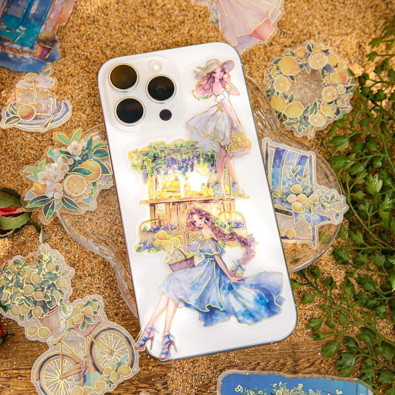 StationeryHaul clear holographic stickers with illustrations of women in summer dresses, fruit stalls, and bicycles with lemon accents.