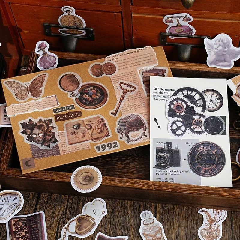 StationeryHaul vintage steampunk decorative stickers featuring butterflies, masks, gears, clocks, and potion bottles in muted browns and grays.