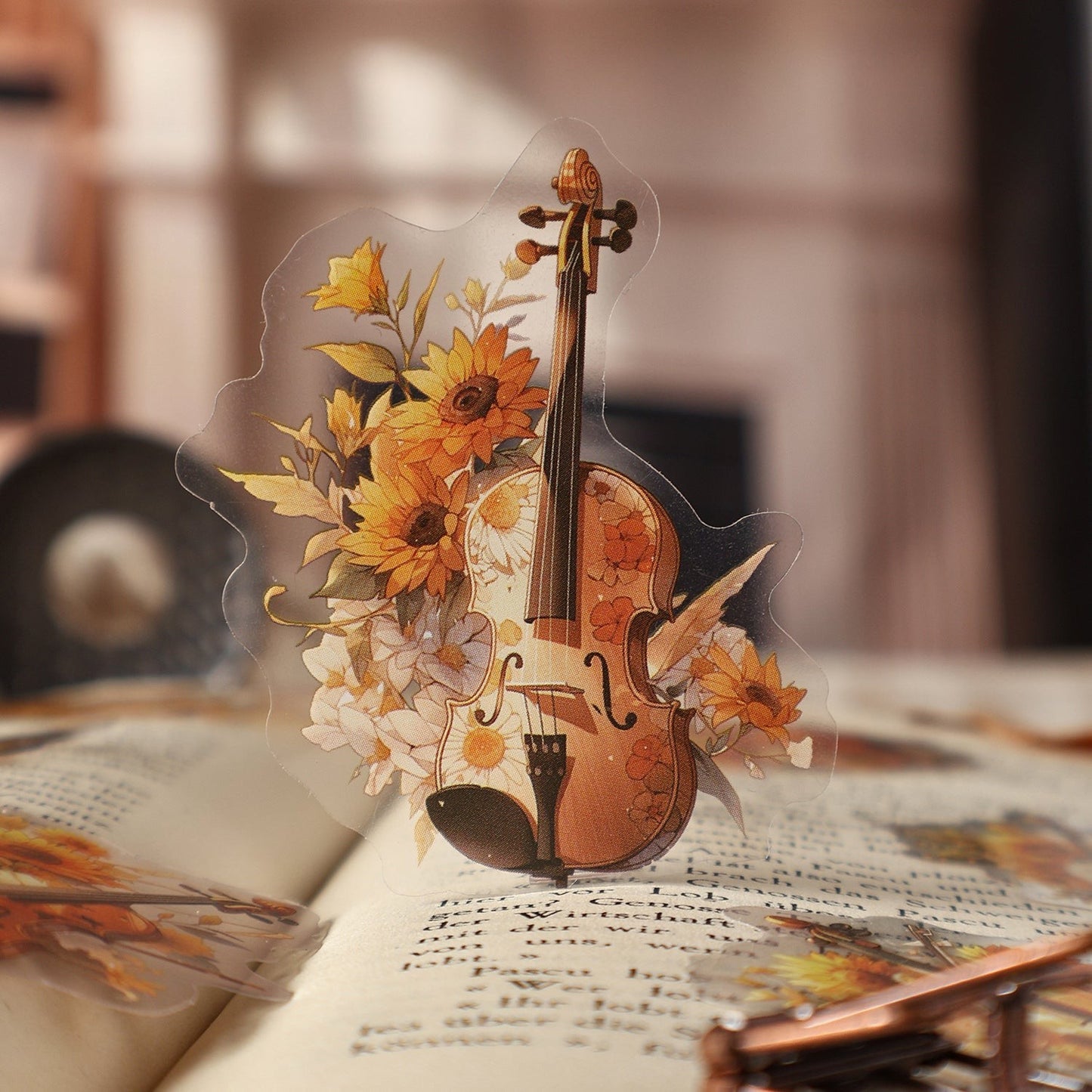 StationeryHaul transparent sticker featuring a violin surrounded by sunflowers and daisies. Ideal for scrapbooking.