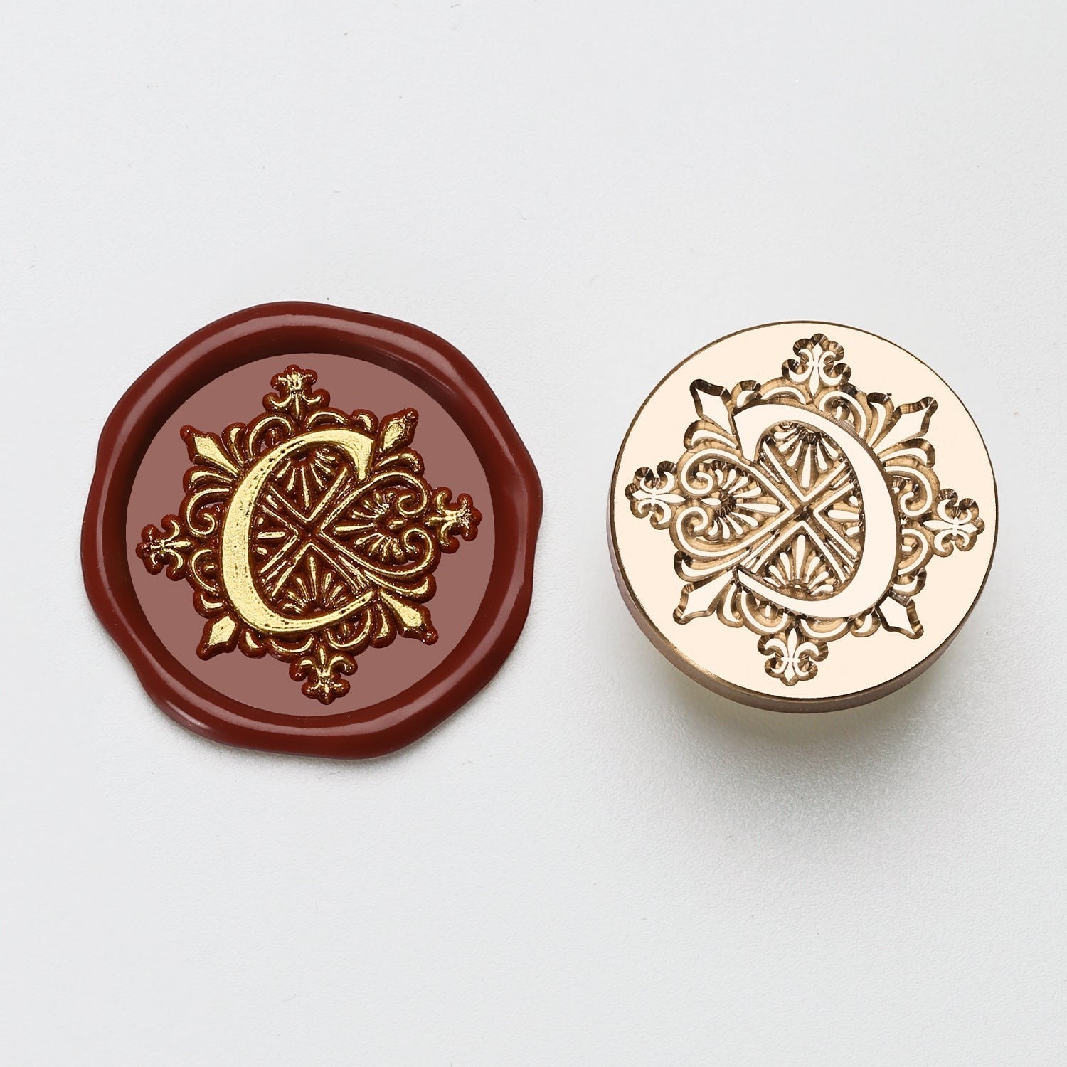 StationeryHaul elegant letter C wax seal stamp with ornate gold detailing on burgundy wax and brass stamp.