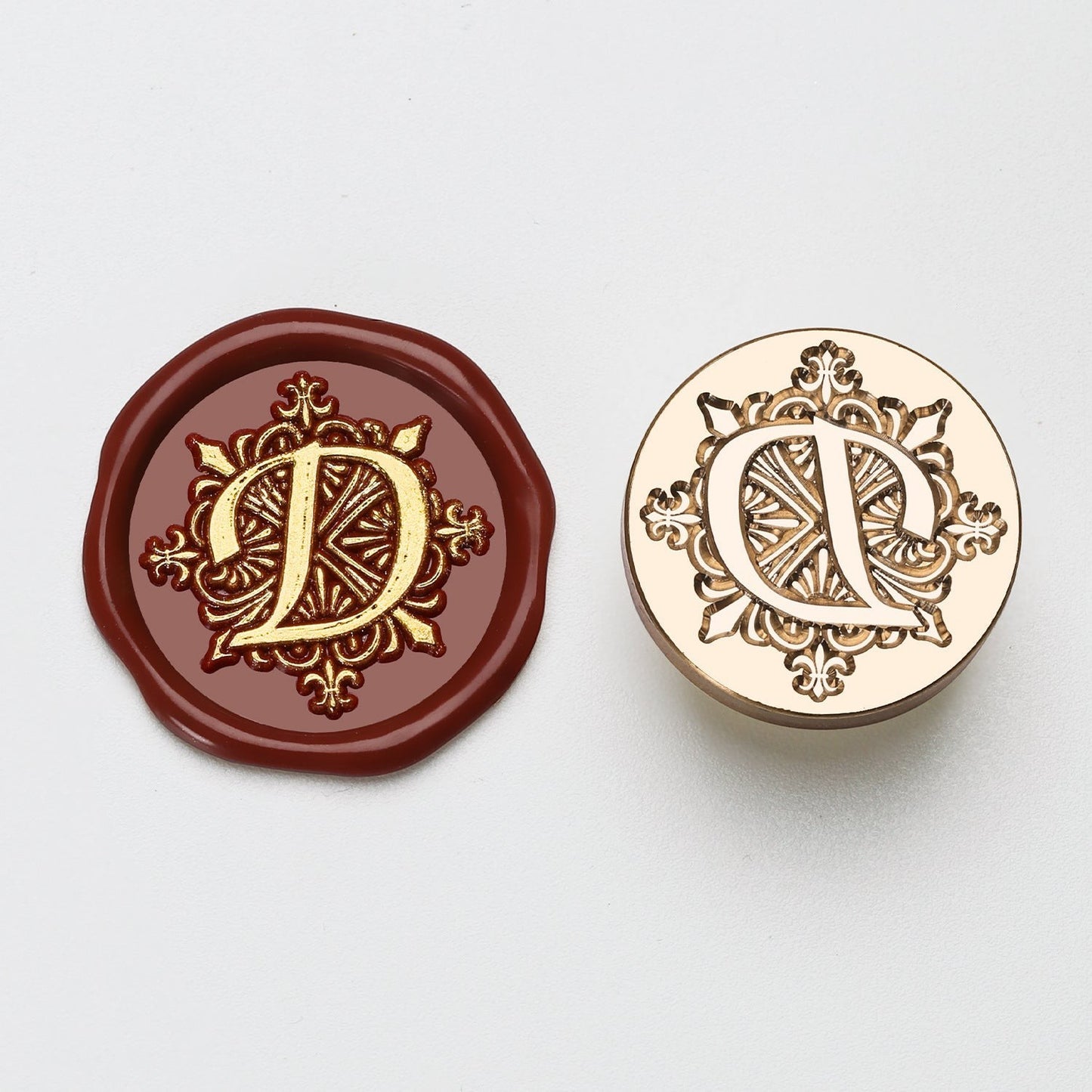 StationeryHaul gold letter D wax seal stamp on burgundy wax and brass stamp.