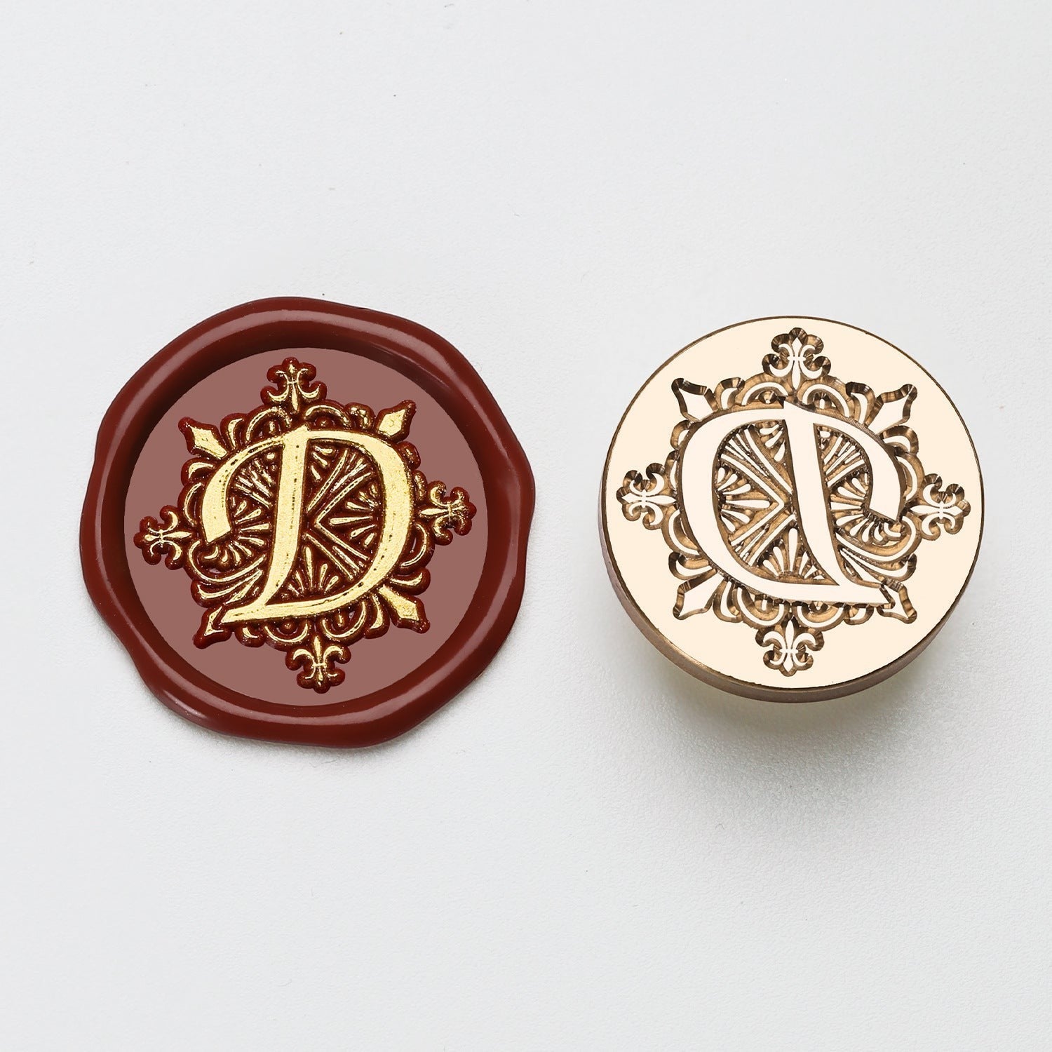 StationeryHaul gold letter D wax seal stamp on burgundy wax and brass stamp.