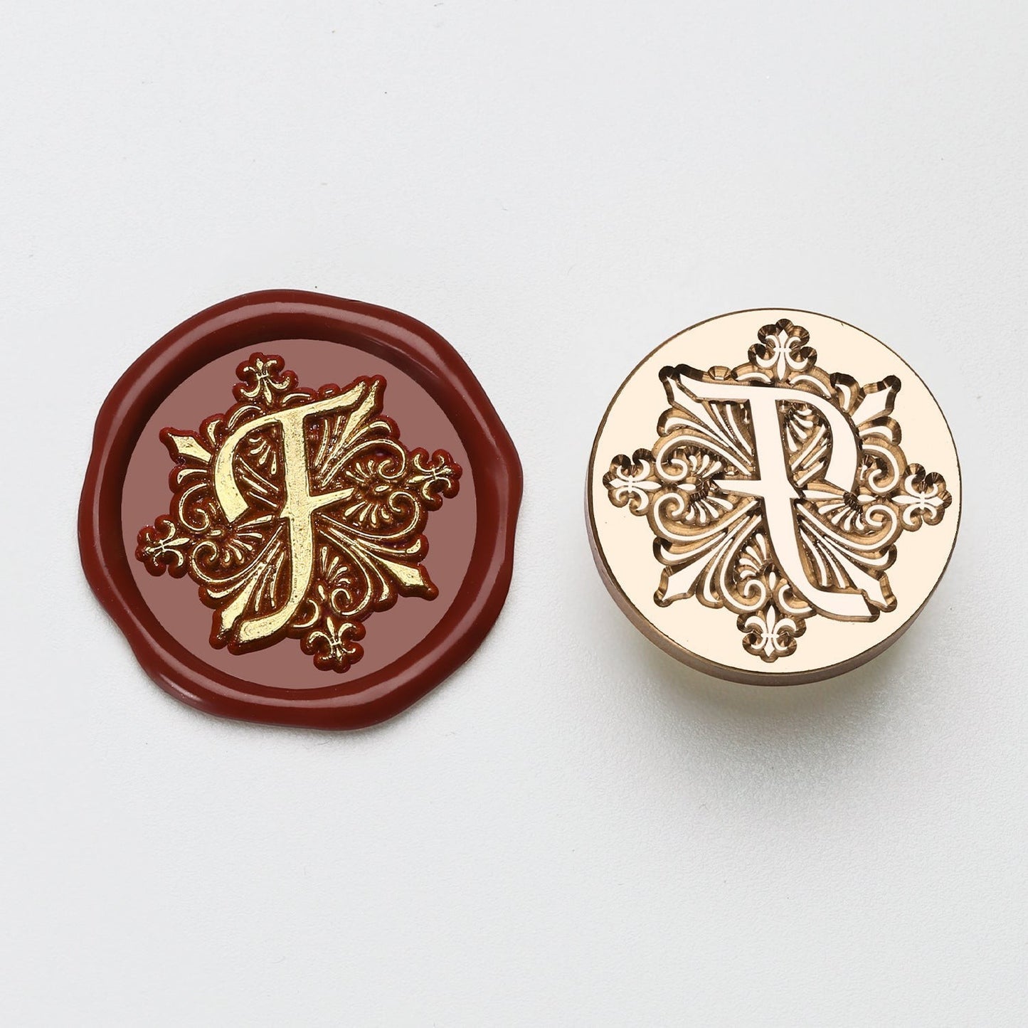 StationeryHaul elegant letter F wax seal stamp with ornate gold details on burgundy wax and brass stamp.