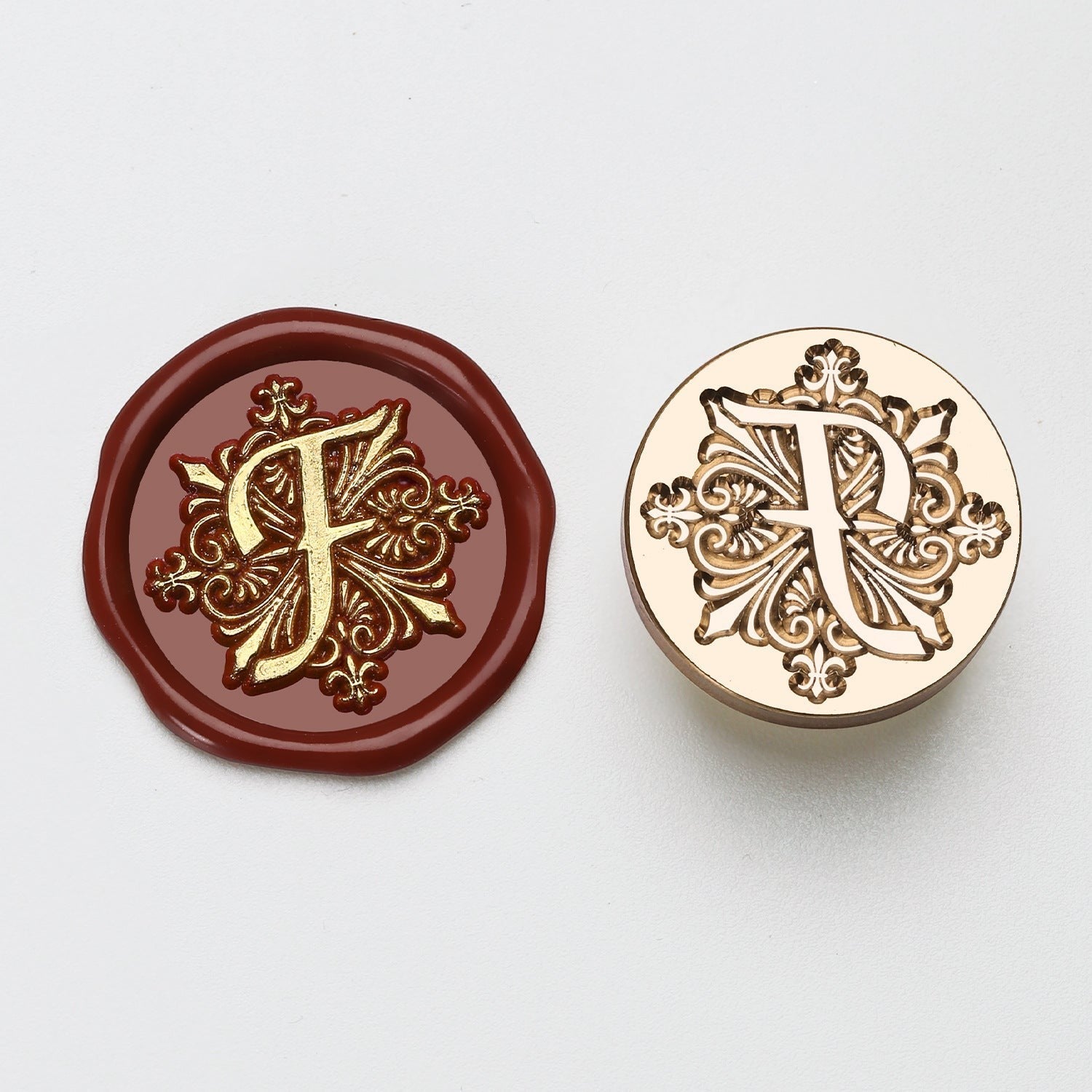 StationeryHaul elegant letter F wax seal stamp with ornate gold details on burgundy wax and brass stamp.