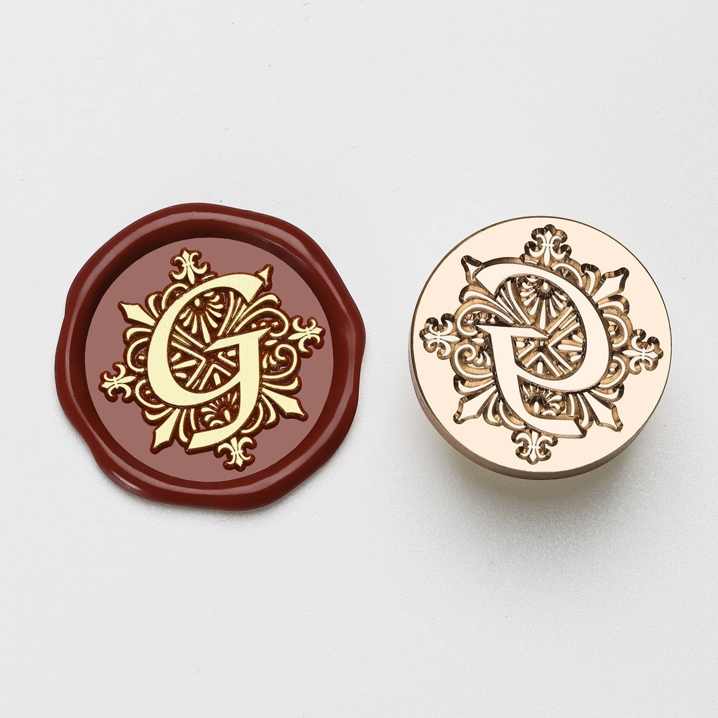 StationeryHaul elegant letter G wax seal stamp in gold on burgundy wax and brass.