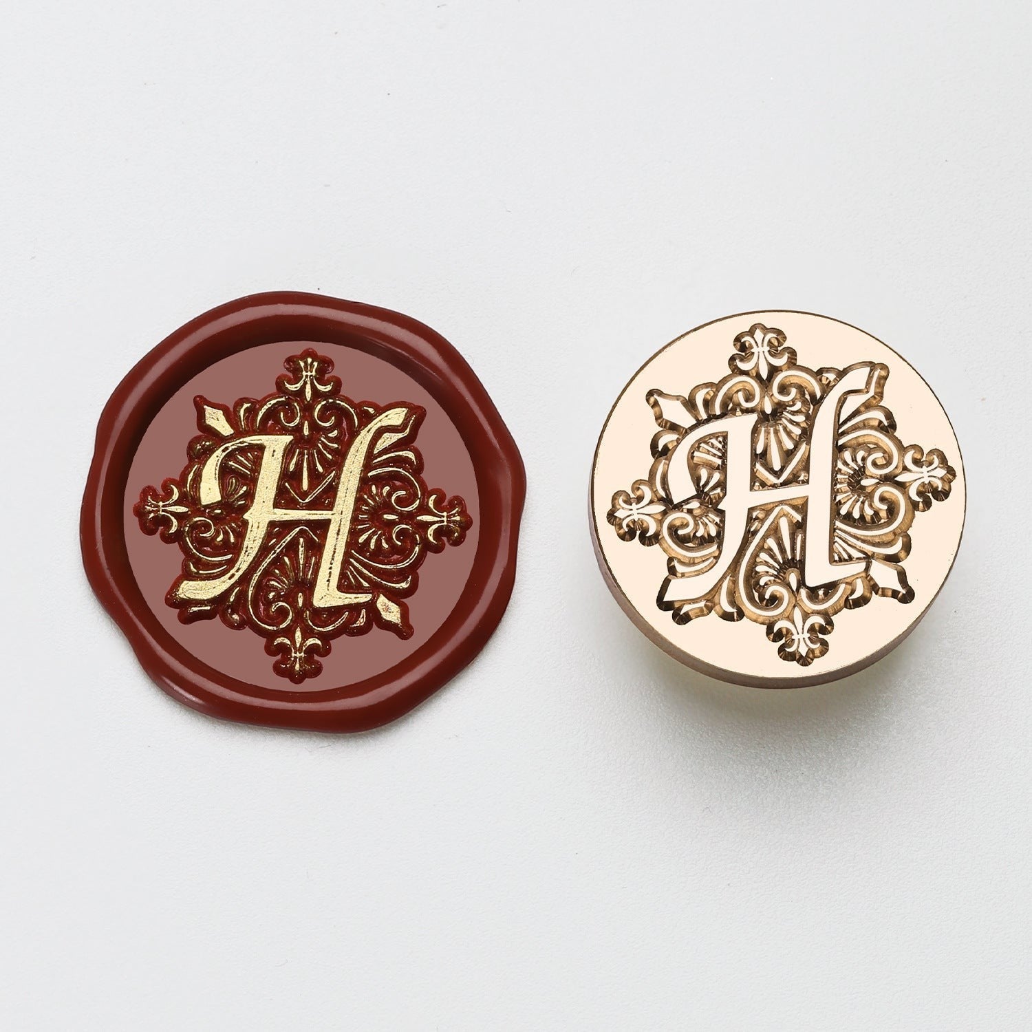 StationeryHaul elegant letter H wax seal stamp with ornate detailing on burgundy wax and gold metal.