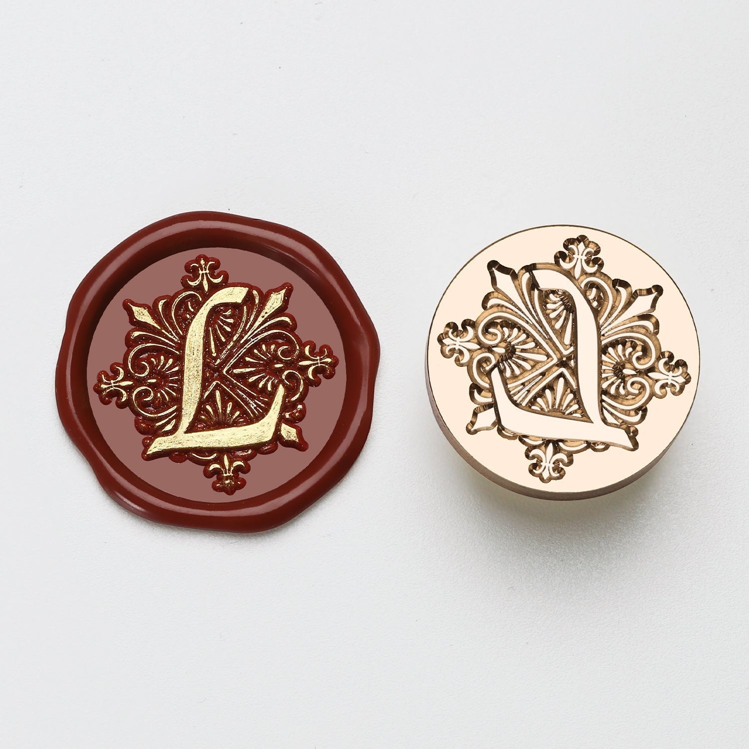 StationeryHaul elegant letter L wax seal stamp with ornate gold detailing on burgundy wax and brass stamp.