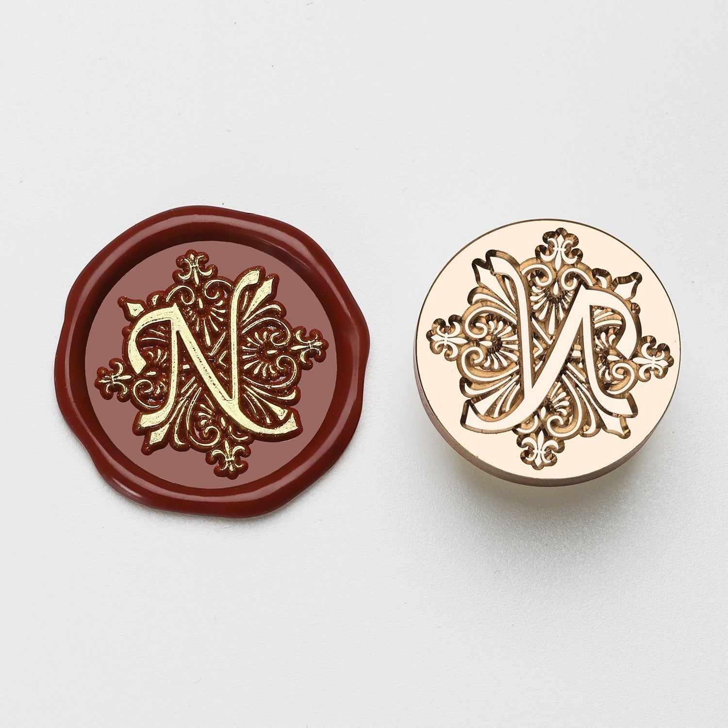StationeryHaul elegant letter N wax seal stamp with ornate details on maroon wax and brass stamp.
