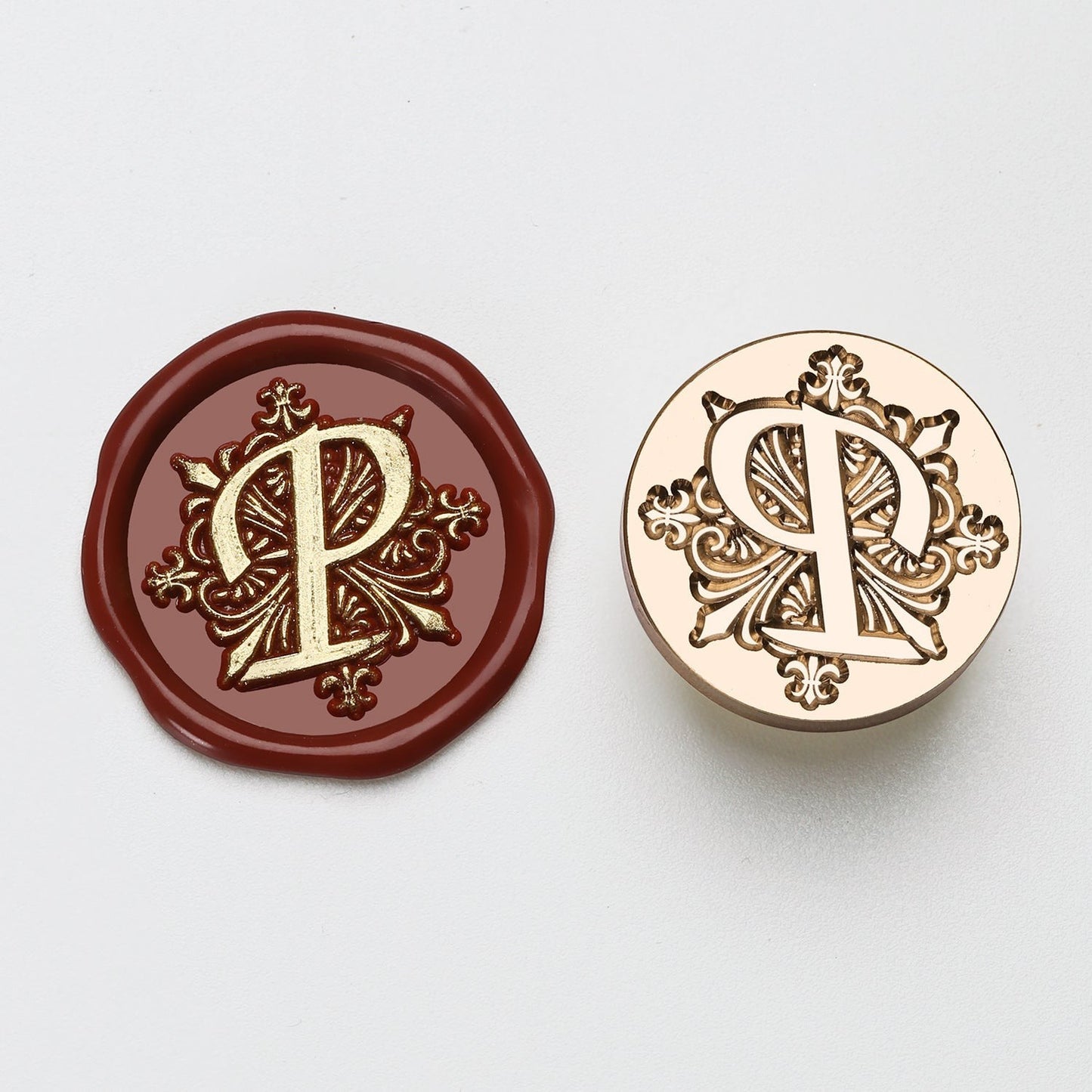 StationeryHaul elegant letter P wax seal stamp with ornate gold details on burgundy wax and brass.
