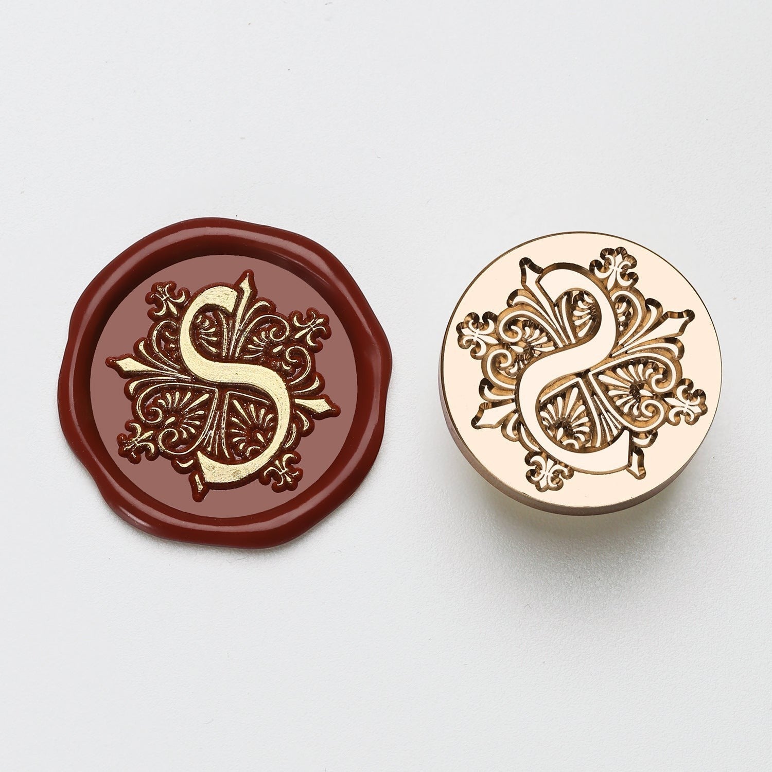 StationeryHaul elegant letter S wax seal stamp with ornate floral design, shown in burgundy wax and brass metal.