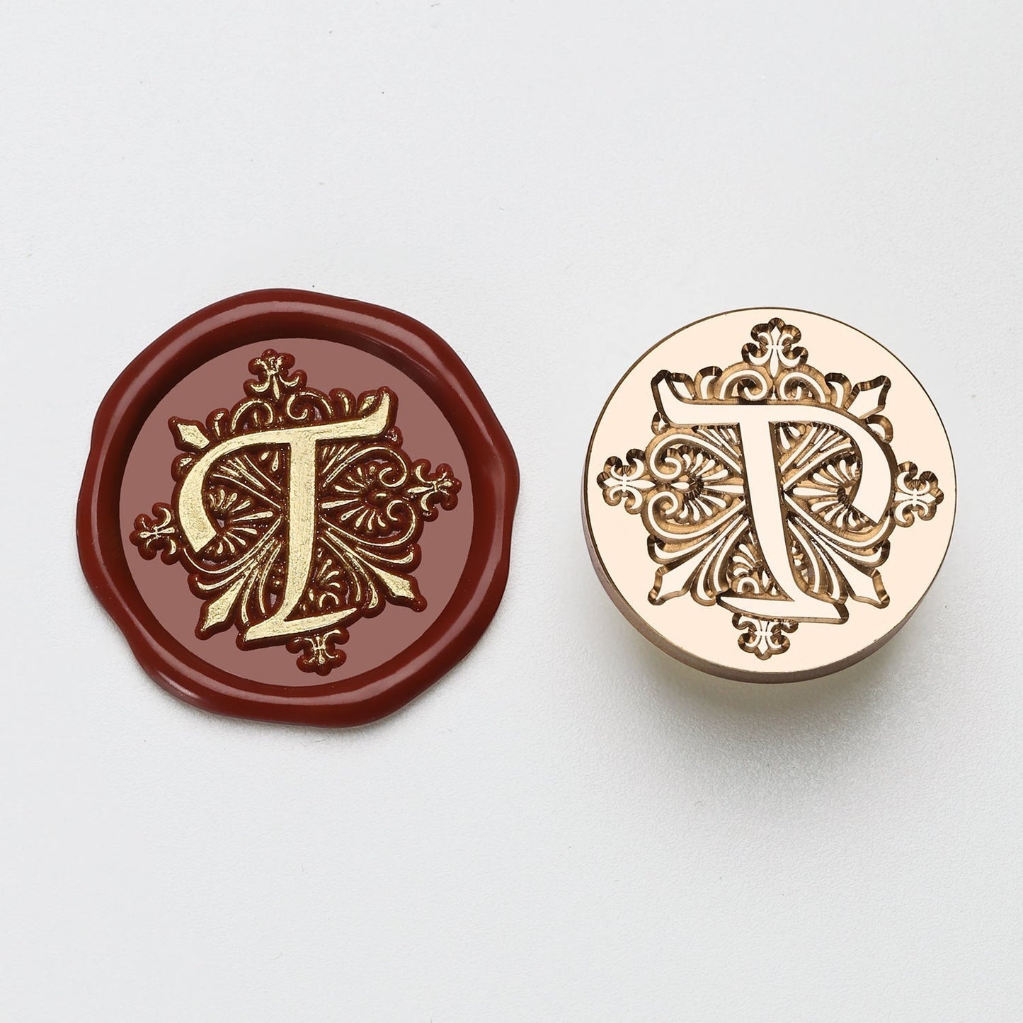 StationeryHaul elegant letter T wax seal stamp with ornate details on burgundy wax and gold metal.