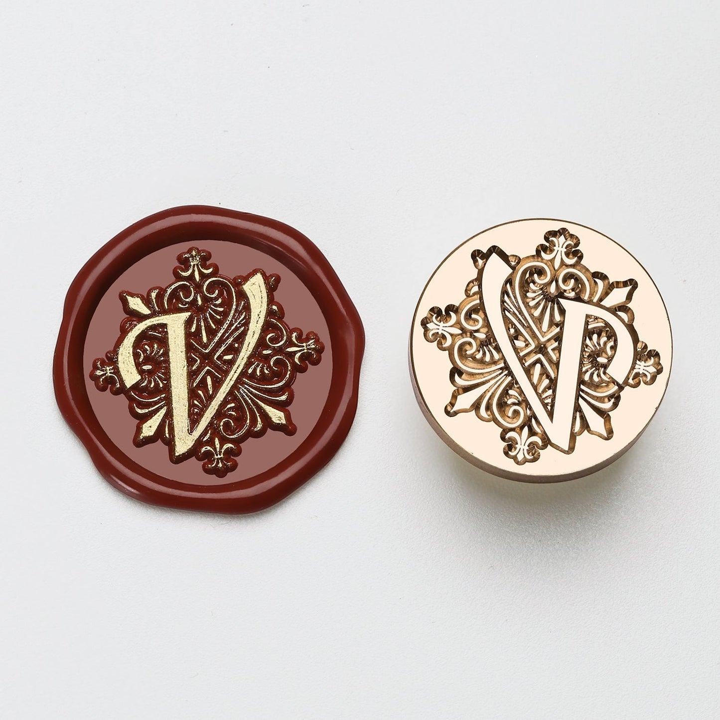 StationeryHaul elegant letter V wax seal stamp with ornate details on burgundy wax and brass stamp.